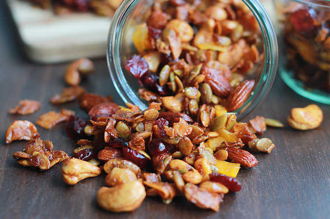 Chipotle trail mix pouring out of glass container onto the table.