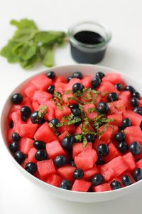 Bowl of watermelon blueberry salad with glaze.