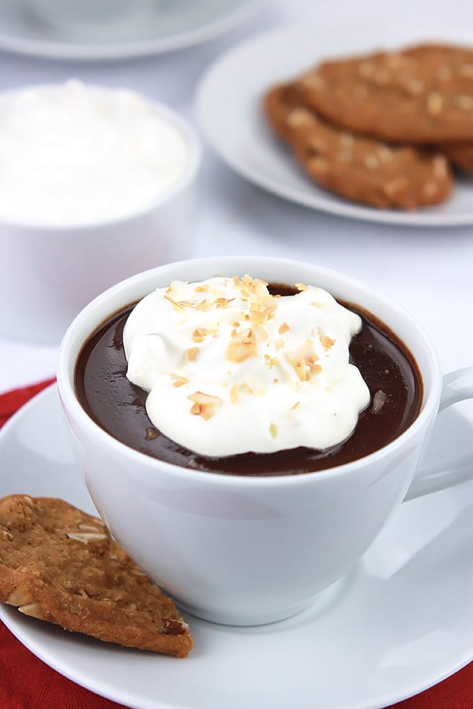 Cozy up with a cup of Decadent Dairy-Free Hot Chocolate topped with creamy coconut cream and toasted coconut.