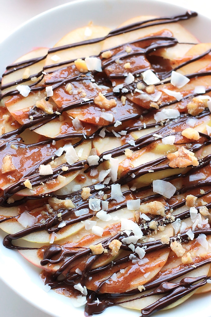 Apple Nachos and Vegan Caramel Sauce - Layers of sweet crisp apple slices garnished with smooth vegan caramel, dark chocolate, walnuts and coconut. It's like eating a delicious candy apple.