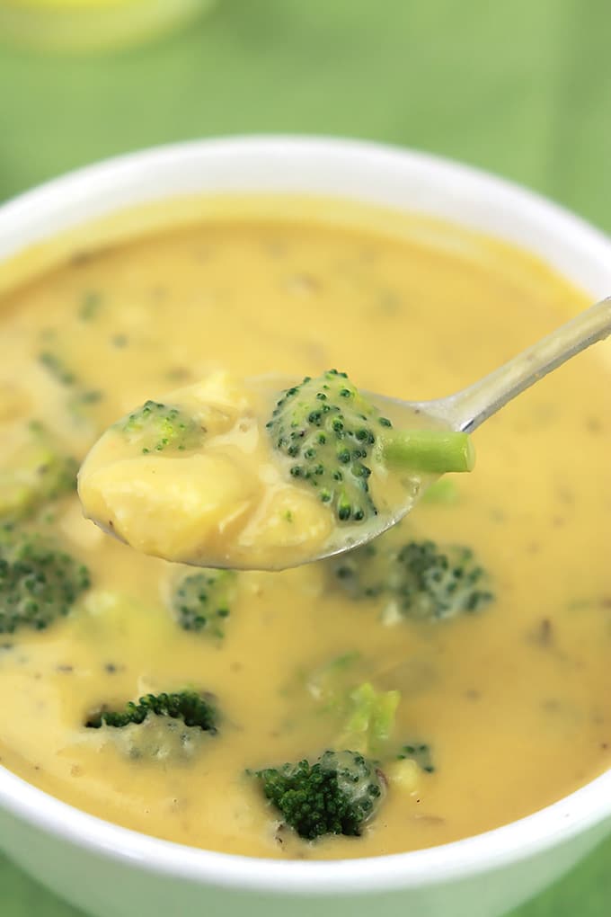 Spoonful of Vegan Un-Cheesy Potato Broccoli Soup over a bowlful of soup.