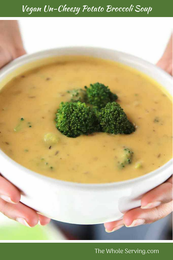 Big bowl of Vegan Un-Cheesy Potato Broccoli Soup with broccoli on top.