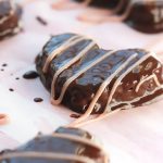 Hazelnuts, dates, and dark chocolate hearts, covered in more smooth creamy dark chocolate, drizzled with raspberry cream. Yum! Make these Chocolate Hazelnut Hearts for someone special, even if that someone special is you.
