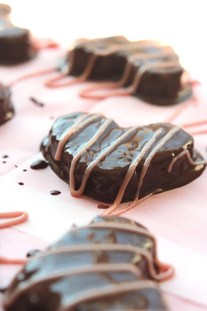 Hazelnuts, dates, and dark chocolate hearts, covered in more smooth creamy dark chocolate, drizzled with raspberry cream. Yum!