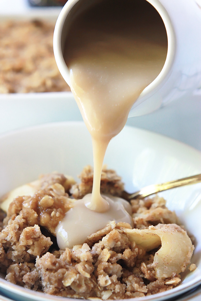 Close-up of brown sugar sauce being poured over Apple Cinnamon Baked Oatmeal. 