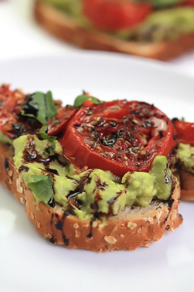 Simple, easy and delicious - Roasted Tomato Avocado Toast. Creamy Avocado mash, sweet roasted tomatoes, drizzled with balsamic glaze, it takes toast to a whole new level.