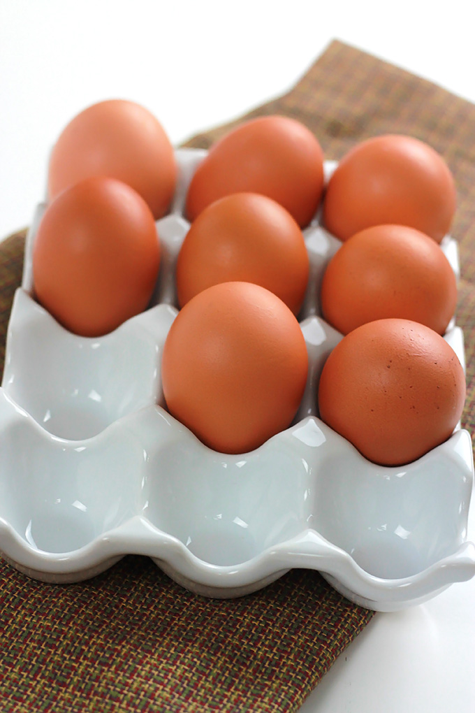 Brown eggs on an egg dish.