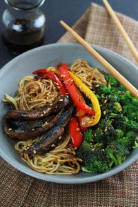 Spicy Ramen Vegetable Stir-Fry in a bowl with red and yellow peppers, mushrooms and broccoli. .