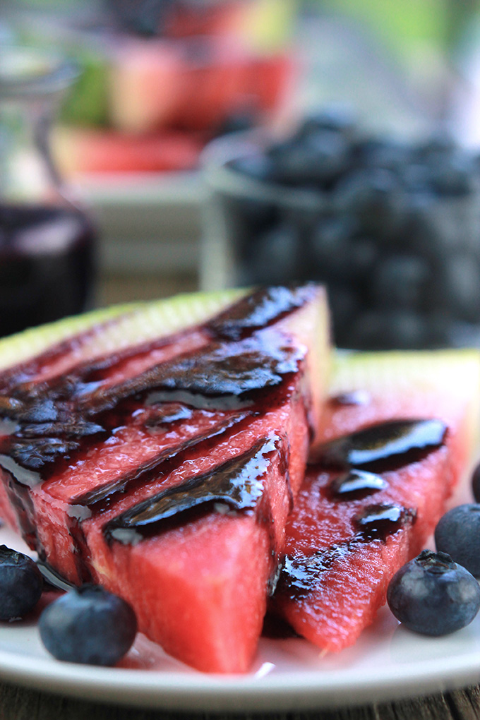 Slices of watermelon drizzled with blueberry glaze.