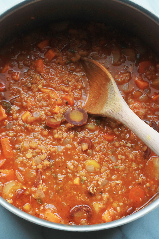 Spicy Lentil Sweet Potato Stew with wooden spoon.