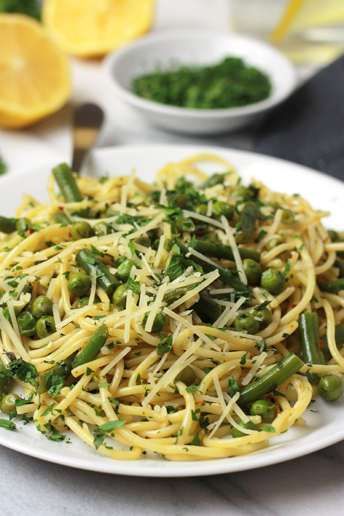 Fresh mix of herbs over crisp veggies and tender pasta finished off with a squeeze of lemon juice, this Herb Green Bean and Pea Pasta sings spring.