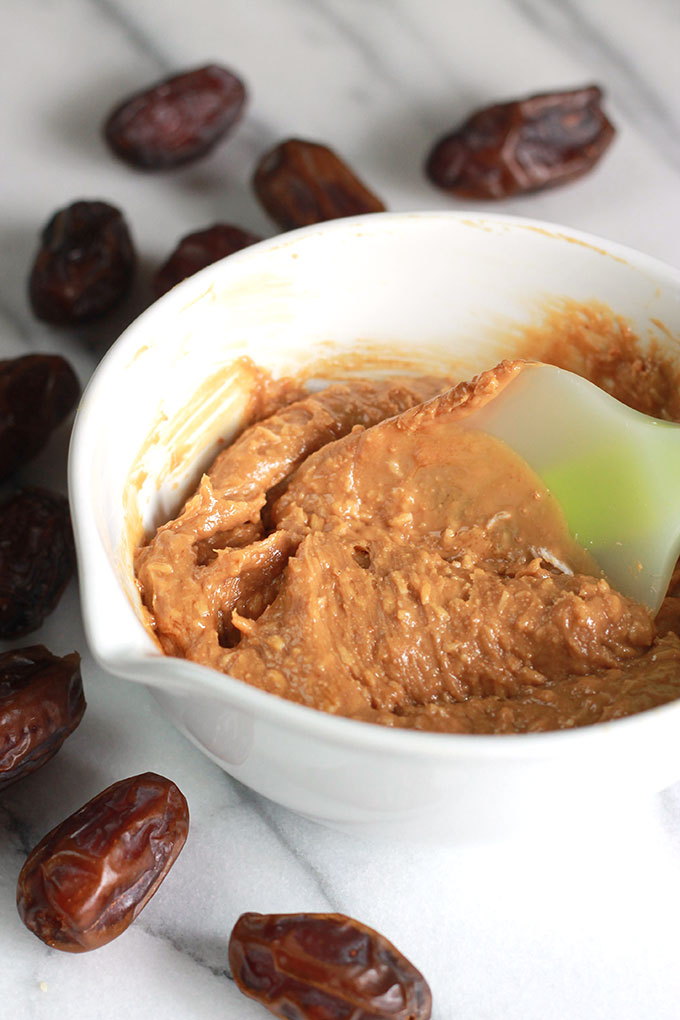 Cashew nut butter in a bowl with dates around outside of bowl.
