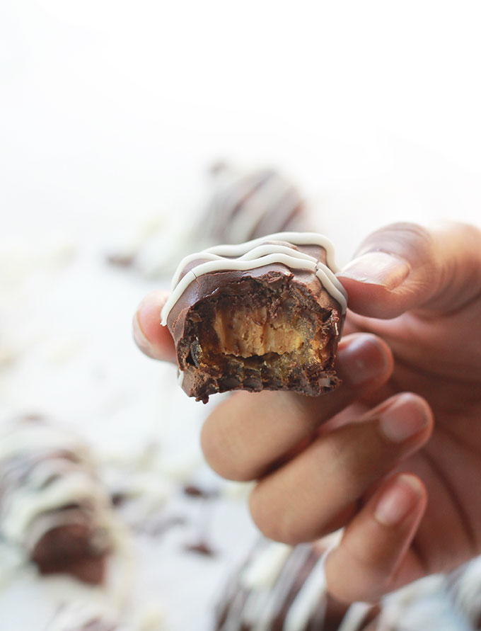 Chocolate Covered Nut Butter Stuffed Date with a bite.