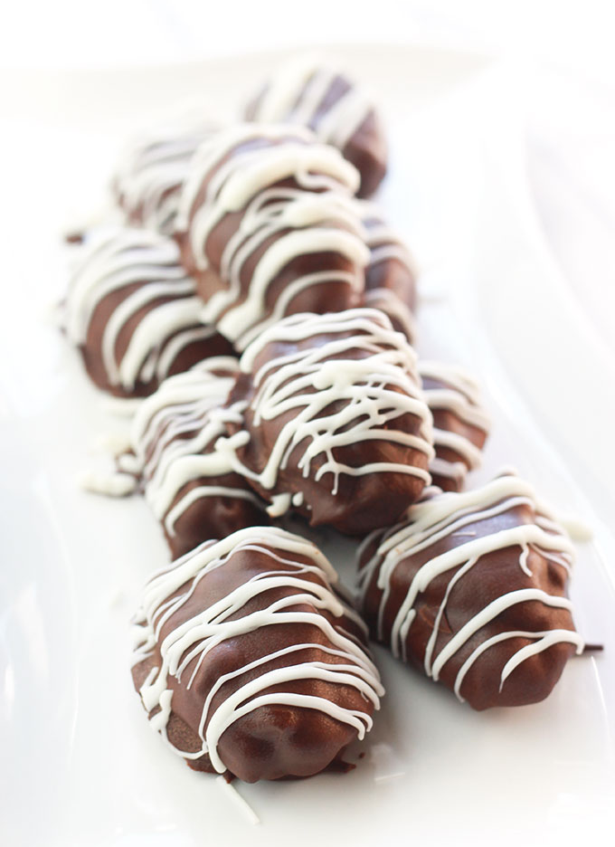 Chocolate Covered Nut Butter Stuffed Dates - Dates stuffed with nut butter, dipped in chocolate and drizzled with smooth, creamy vegan white chocolate. Pure Deliciousiness.
