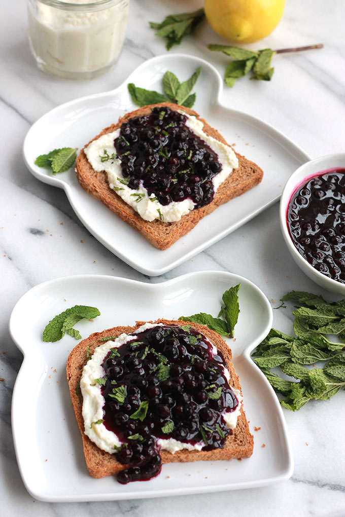 Lemon Ricotta Toast with Wild Blueberry Sauce-Lightly sweetened creamy lemon ricotta on toast topped with sweet juicy wild blueberry sauce, sprinkled with mint. Sumptuosity on a plate.