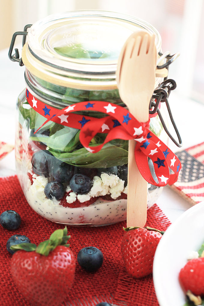 Layers of fruit, creamy goat cheese and lettuce, this Red White & Blue Salad with Poppy Seed Dressing is colorful and perfect for patriotic celebrations.