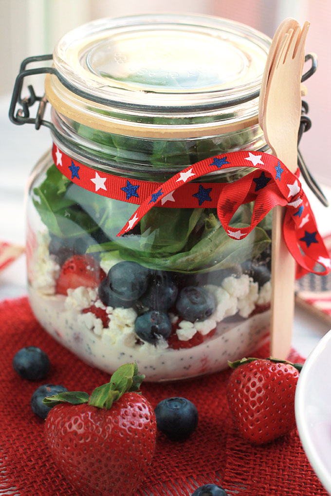 Layers of fruit, creamy goat cheese and lettuce, this Red White & Blue Salad with Poppy Seed Dressing is colorful and perfect for patriotic celebrations.