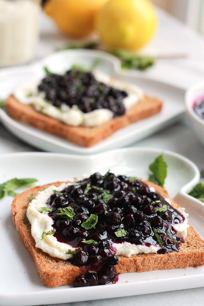 Lemon Ricotta Toast with Wild Blueberry Sauce-Lightly sweetened creamy lemon ricotta on toast topped with sweet juicy wild blueberry sauce, sprinkled with mint. Sumptuosity on a plate.