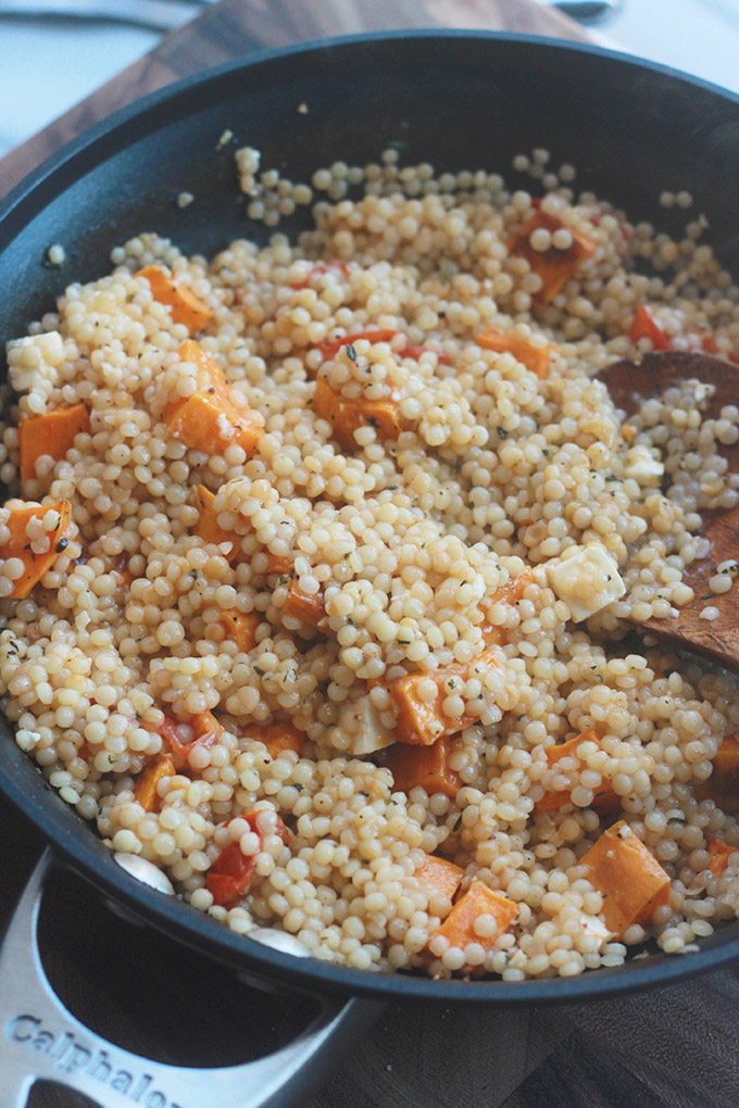 Ready for a supercharged, healthy, hearty salad?  You're going to love this Israeli Couscous Kale Salad with Feta it's made with tender Israeli Couscous, roasted tomatoes, sweet potatoes and chickpeas tossed with seasoned fresh