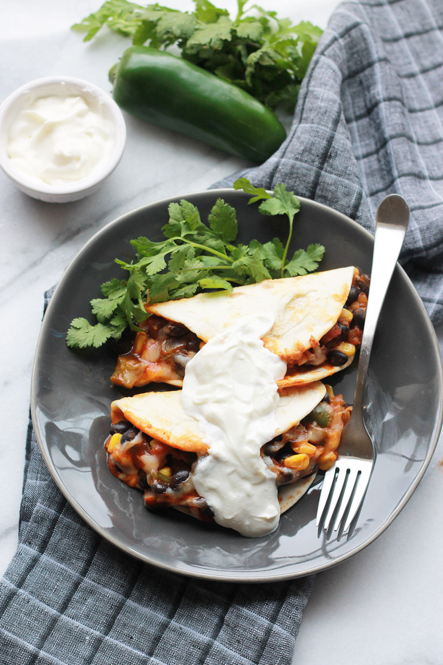  Baked Black Bean Tacos with Red Chile Sauce on plate with sour cream