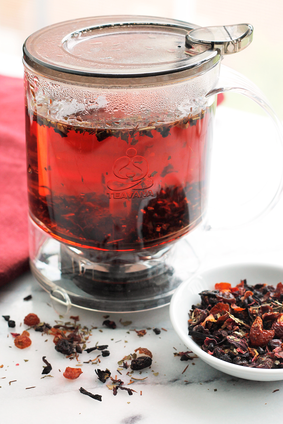 Shot of hibiscus tea in tea maker infuser.