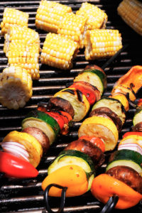 Veggie kabobs and corn on the grill.