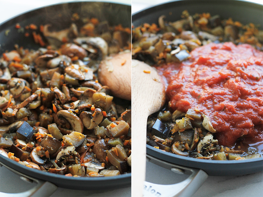 Eggplant and mushroom in saute pan with tomato sauce on top.