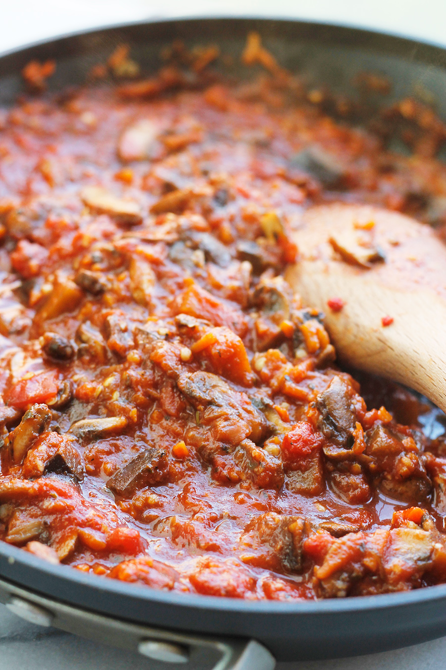 Simmering Vegan Eggplant Mushroom Sauce in saute pan.