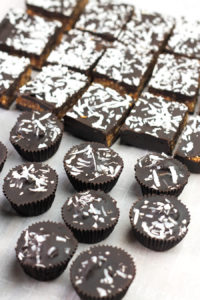 Angled shot of Coconut Cashew Chocolate Cups and Bars.