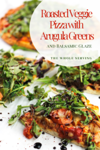 Slices of roasted veggie pizza topped with arugula and drizzled with balsamic glaze.