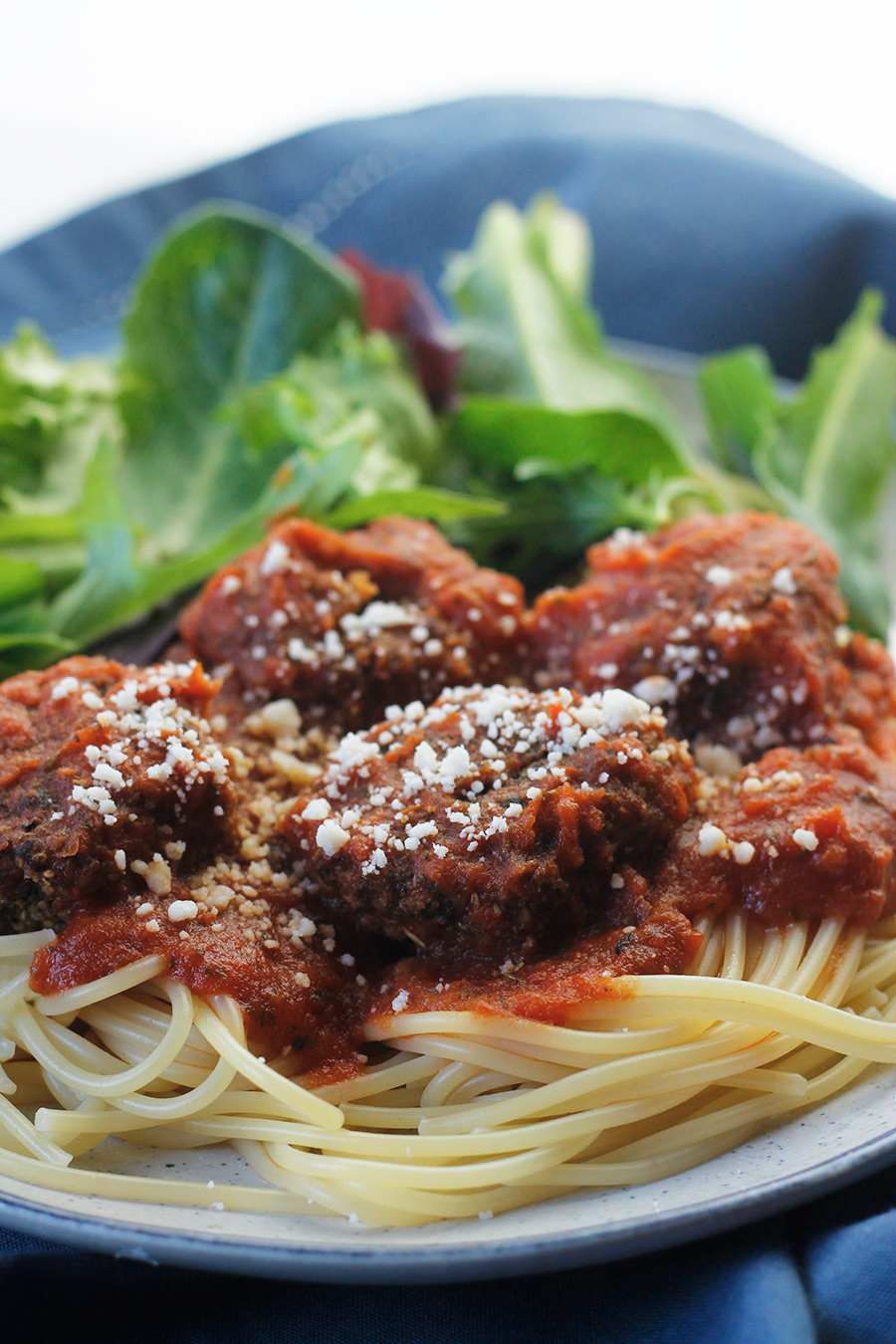 Close-up of easy meatless meatballs over pasta and pasta sauce.