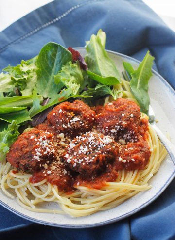 Ovehead angled shot of easy meatless meatball on a bed of pasta and pasta sauce.