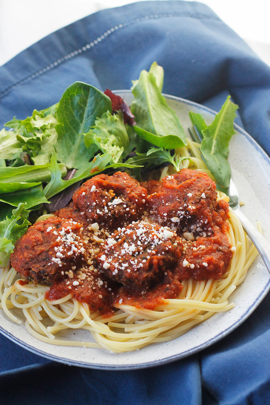 Ovehead angled shot of easy meatless meatball on a bed of pasta and pasta sauce.