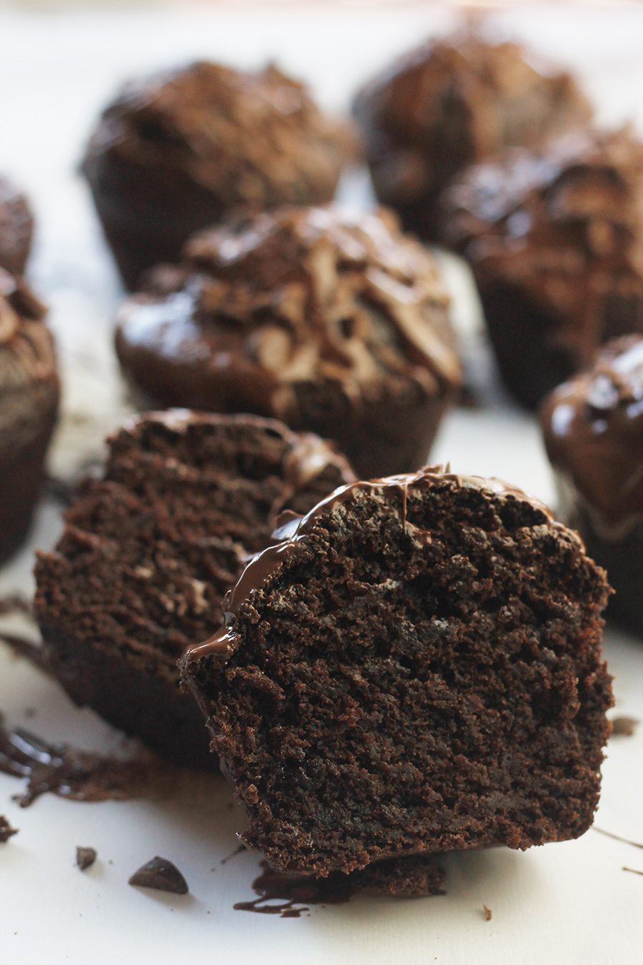 Close-up of chocolate-on-chocolate vegan cupcake cut in half.
