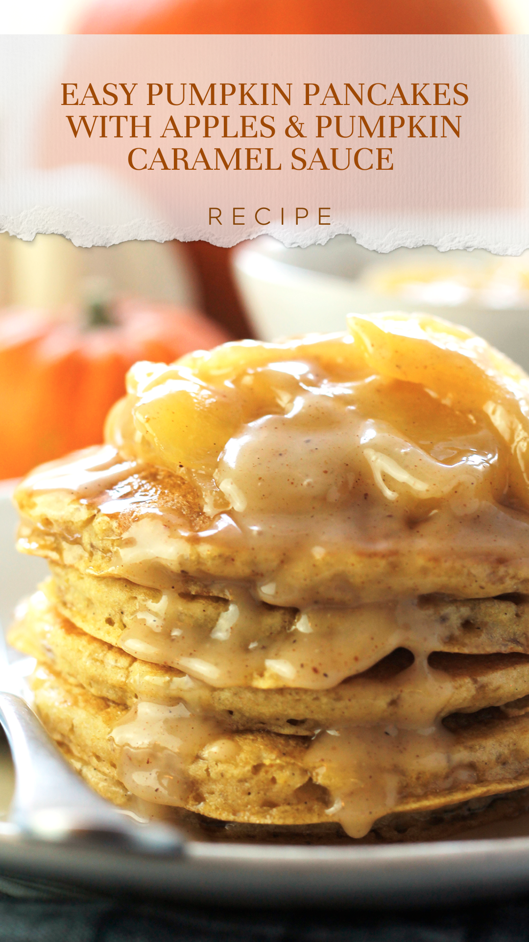 A close-up shot of a stack of pumpkin pancakes on a plate with apples and pumpkin caramel sauce on top. A large orange pumpkin, medium white pumpkin and a small orange pumpkin in the background. A bowl of extra apple pumpkin sauce to the top right of the plate of pancakes. 