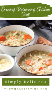 Angled shot of two bowls of creamy rosemary chicken soup. Bowl in the front right has a small white bowl filled with shredded parmesan cheese and the bowl to the back left has a piece of crusty bread on the right side of the bowl.