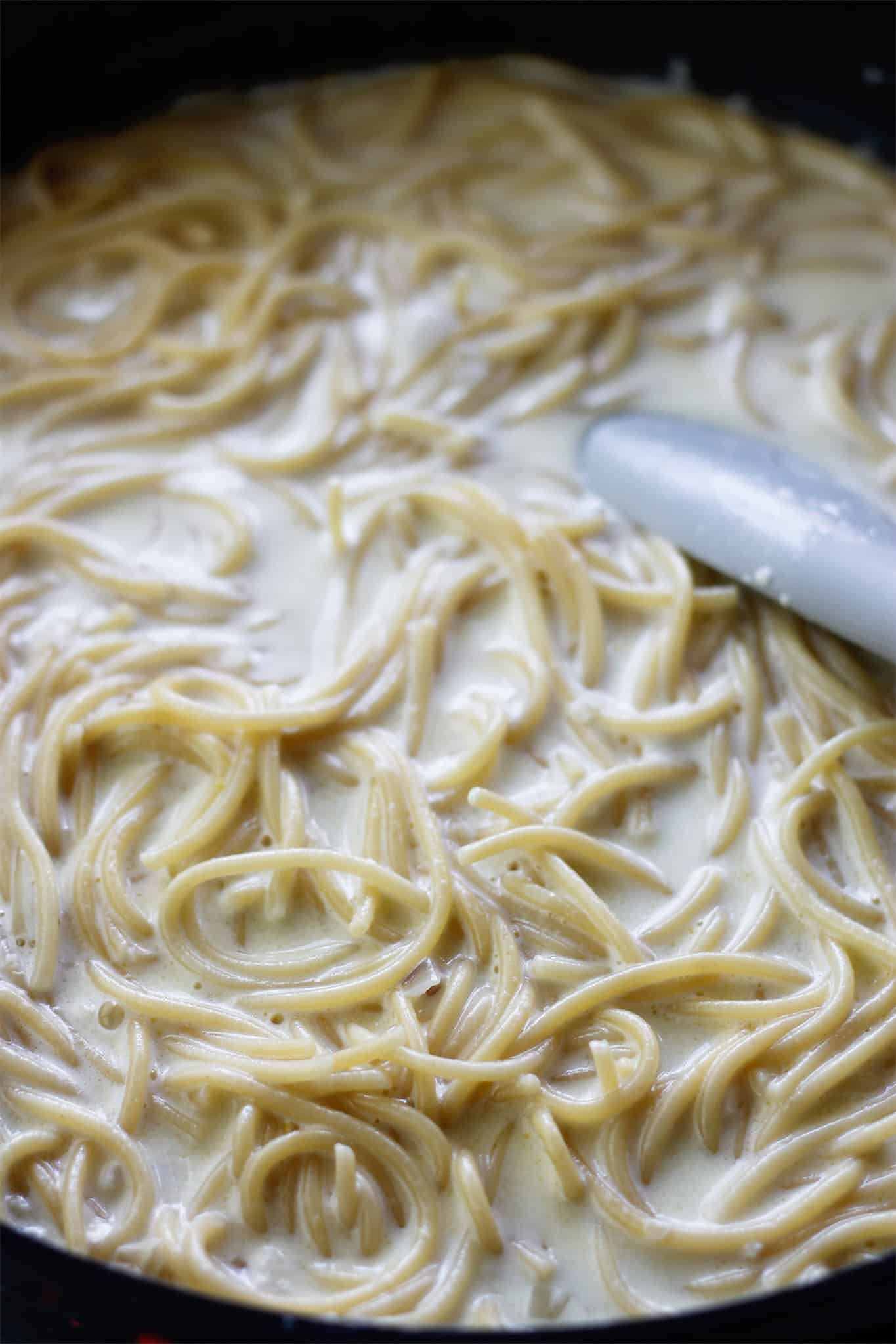 Pasta added to pan with cream sauce.