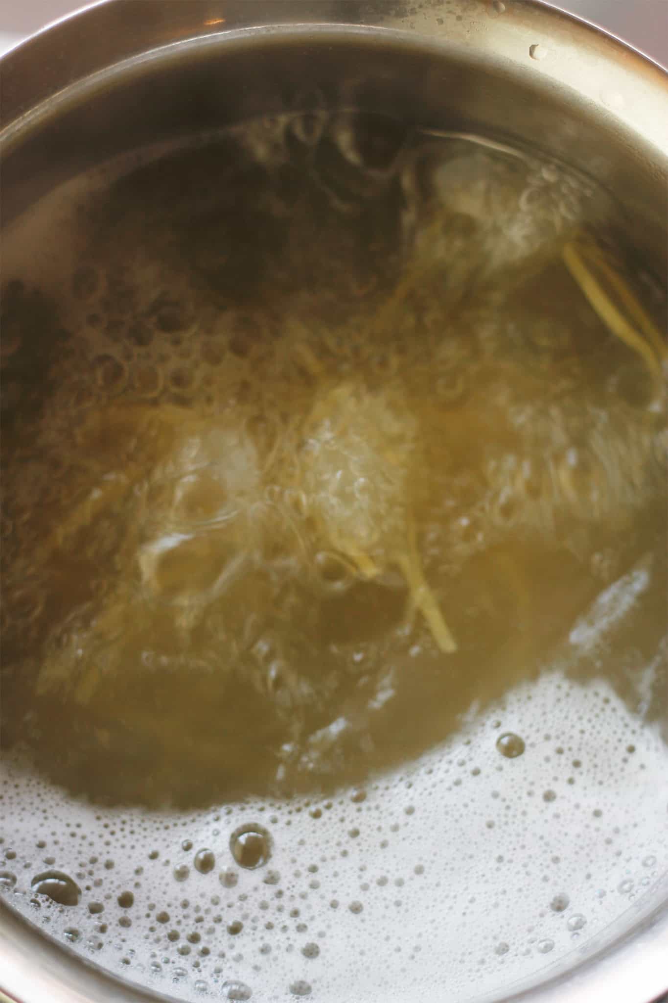 Overhead shot of pasta cooking in boiling water.