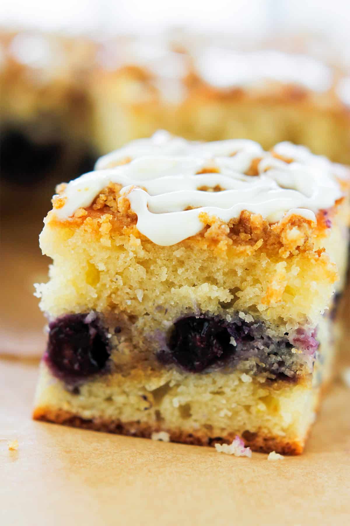 Close-up shot of square slice of lemon blueberry crumb cake.