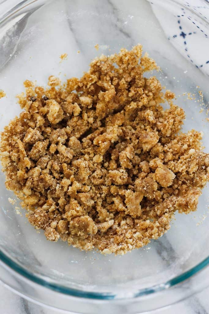 Overhead shot of prepared crumb mixture in a glass bowl.