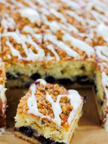 Overhead shot of sliced crumb cake with one square slice in front of cake.