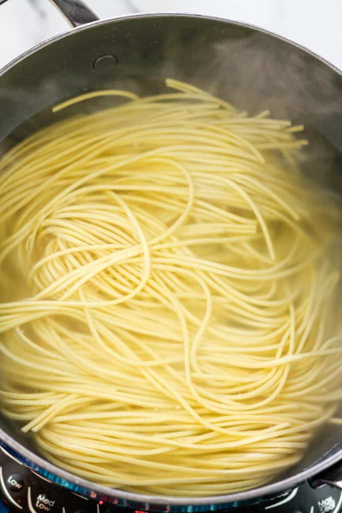 Overhead shot of pasta in pot of hot water.