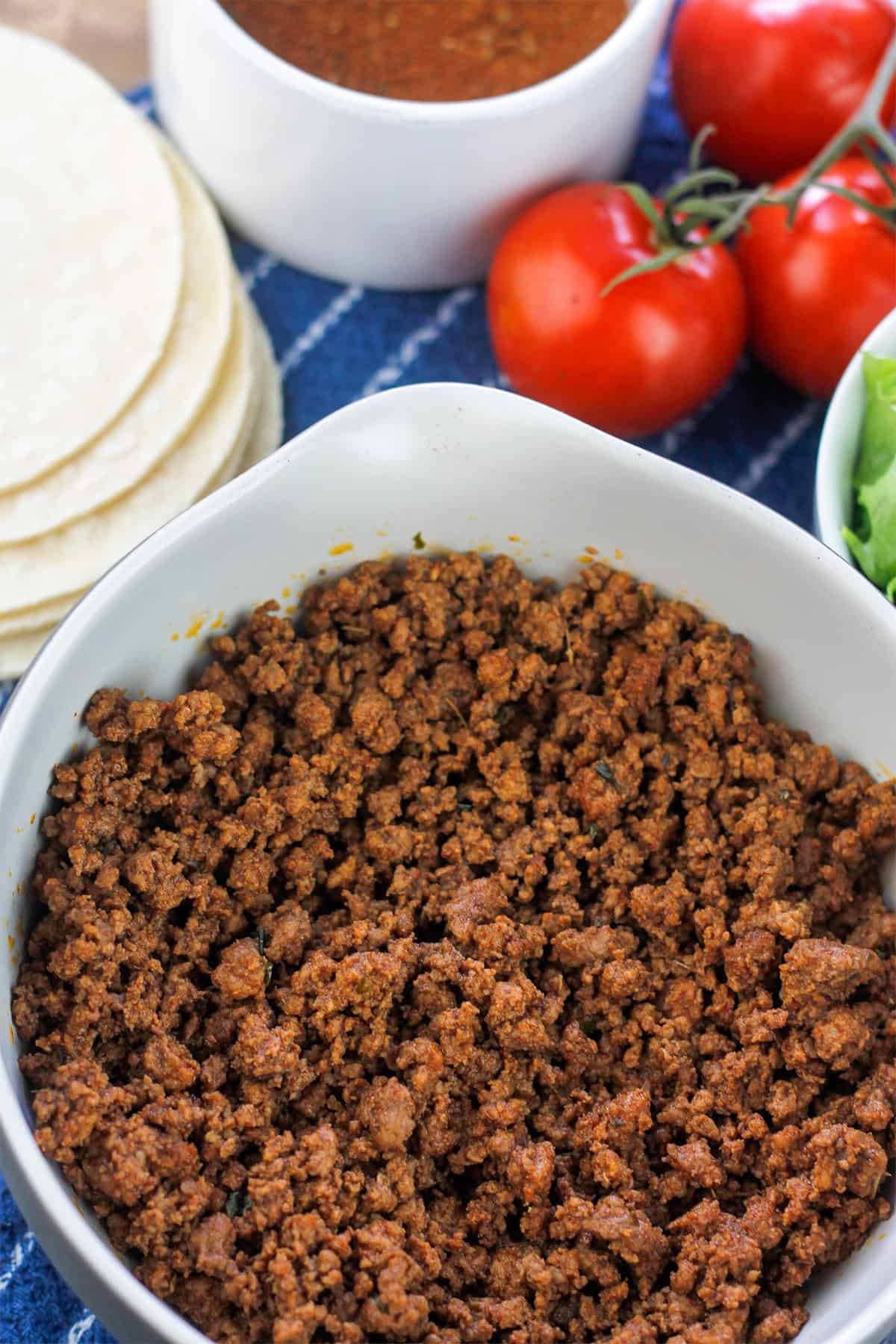 Cooked ground beef seasoned with DIY taco seasoning in a bowl.