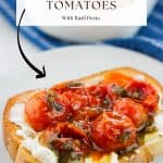 Roasted tomatoes on toast with a container of roasted tomatoes in the background.