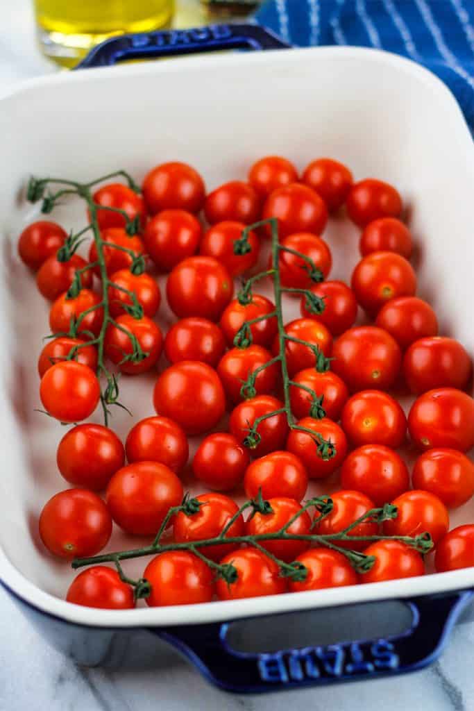 Washed and dried cherry tomatoes in a rectangle baking dish