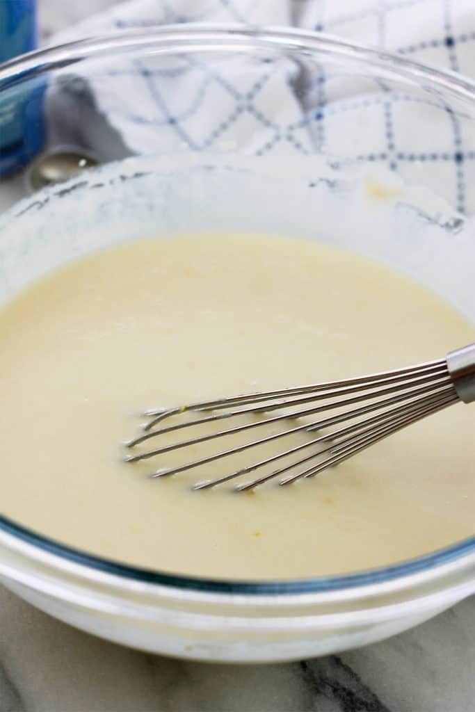 Wet- ingredients for the crumb cake whisked in a glass bowl.