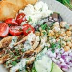 Shot of Mediterranean grain bowl with grilled chicken and fresh vegetables.