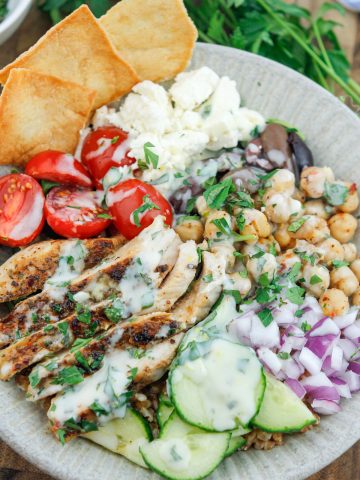 Shot of Mediterranean grain bowl with grilled chicken and fresh vegetables.