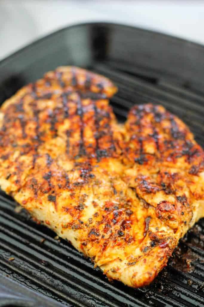 Grilled chicken for grain bowl on a cast iron grill pan.