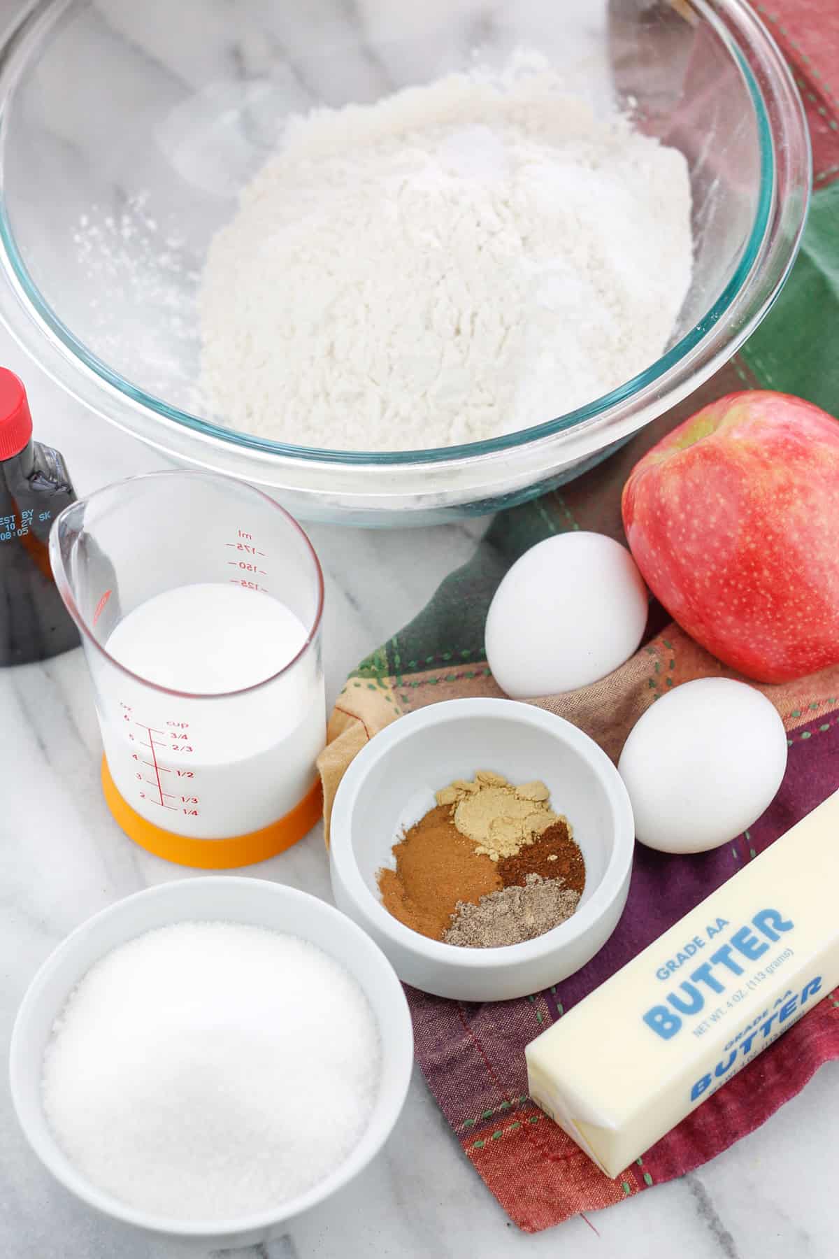 Overhead shot of chai apple muffins ingredients on countertop.